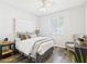 Bright bedroom with wood floors, a large bed, and a comfortable armchair at 10637 W Eucalyptus Rd, Peoria, AZ 85383