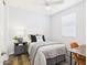 Neutral bedroom with a comfortable bed, stylish nightstand, and a ceiling fan at 10637 W Eucalyptus Rd, Peoria, AZ 85383