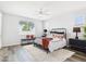 Well-lit bedroom with a decorative rug, ceiling fan, and large window at 10637 W Eucalyptus Rd, Peoria, AZ 85383