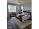 Bright bedroom features a wrought iron bed frame, large windows, and a neutral color palette, creating a soothing retreat at 10637 W Eucalyptus Rd, Peoria, AZ 85383