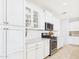 Beautiful white kitchen features stainless steel appliances and herringbone tile backsplash at 10637 W Eucalyptus Rd, Peoria, AZ 85383