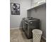 Laundry room with modern washer and dryer, storage shelves, and decorative accents at 10637 W Eucalyptus Rd, Peoria, AZ 85383