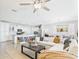 Bright, open-concept living area with a view into the modern kitchen with stainless steel appliances and a dining space at 10637 W Eucalyptus Rd, Peoria, AZ 85383