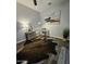 Modern home office with glass desk, stylish rug, and neutral décor, offering a functional and attractive workspace at 10637 W Eucalyptus Rd, Peoria, AZ 85383