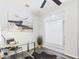 Bright office space with a glass-topped desk, modern lighting, and stylish décor, seamlessly connecting to other spaces at 10637 W Eucalyptus Rd, Peoria, AZ 85383