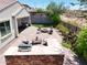 Spacious patio area featuring an outdoor kitchen, fire pit, and shaded seating, perfect for entertaining at 10637 W Eucalyptus Rd, Peoria, AZ 85383