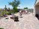 Inviting outdoor living space featuring a fire pit, built-in grill, and stylish seating area at 10637 W Eucalyptus Rd, Peoria, AZ 85383