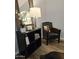 Charming sitting area featuring a classic leather chair, decorative mirror, and stylish accessories, creating a cozy corner at 10637 W Eucalyptus Rd, Peoria, AZ 85383
