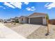 Charming single-story home featuring a paved driveway and low-maintenance landscaping at 18525 E Dario Rd, Gold Canyon, AZ 85118