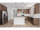 Modern kitchen features stainless steel appliances, an island with bar seating, and stylish pendant lighting at 18525 E Dario Rd, Gold Canyon, AZ 85118