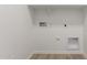 Bright laundry room featuring new connections and stylish laminate flooring for easy maintenance at 18525 E Dario Rd, Gold Canyon, AZ 85118