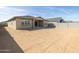 Spacious backyard featuring a covered patio with sliding glass doors, and block fencing at 37014 W La Paz St, Maricopa, AZ 85138
