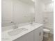 Bathroom with double sink vanity, large mirror, and tiled floor at 37014 W La Paz St, Maricopa, AZ 85138