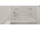 All-white bathroom with tub and shower at 37014 W La Paz St, Maricopa, AZ 85138
