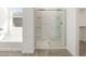 Bathroom featuring a glass shower door and tub at 37014 W La Paz St, Maricopa, AZ 85138