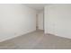 A comfortable bedroom space with neutral carpet and white walls at 37014 W La Paz St, Maricopa, AZ 85138