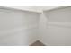 Spacious walk-in closet with built-in shelving and carpeted floor at 37014 W La Paz St, Maricopa, AZ 85138