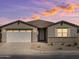 Charming single-story home featuring a two-car garage and professionally landscaped front yard at 37014 W La Paz St, Maricopa, AZ 85138