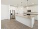Bright, modern kitchen with stainless steel appliances, granite countertops, and large island at 37014 W La Paz St, Maricopa, AZ 85138