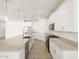 Modern kitchen with granite countertops, stainless steel appliances, and white cabinetry at 37014 W La Paz St, Maricopa, AZ 85138