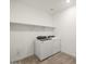 Convenient laundry room with modern appliances and built-in shelving at 37014 W La Paz St, Maricopa, AZ 85138