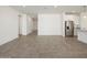 Spacious living room featuring tile flooring, stainless steel appliances, and modern design at 37014 W La Paz St, Maricopa, AZ 85138