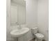 Well-lit half-bathroom with a pedestal sink and modern fixtures at 37014 W La Paz St, Maricopa, AZ 85138