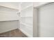 Spacious walk-in closet featuring built-in shelving and ample storage at 37014 W La Paz St, Maricopa, AZ 85138