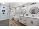 Modern bathroom featuring a soaking tub, double vanity with sinks, and a glass-enclosed shower at 1413 E Windsor Ave, Phoenix, AZ 85006