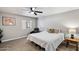 This bedroom features neutral walls, carpet, a ceiling fan, and a window for plenty of natural light at 1413 E Windsor Ave, Phoenix, AZ 85006