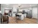 This modern kitchen features stainless steel appliances, an island with seating, and it opens to the dining and living areas at 1413 E Windsor Ave, Phoenix, AZ 85006