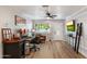 Inviting living room with wood floors, neutral walls, ceiling fan, and a stylish workstation by the front door at 1413 E Windsor Ave, Phoenix, AZ 85006