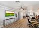 This living room features hard floors, a ceiling fan, a flat screen television, and is adjacent to the kitchen at 1413 E Windsor Ave, Phoenix, AZ 85006