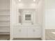 Bathroom with double vanity and built-in shelving at 37405 W San Clemente St, Maricopa, AZ 85138
