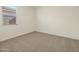 Simple bedroom with neutral carpeting and a window at 37405 W San Clemente St, Maricopa, AZ 85138
