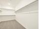 Walk-in closet with double hanging rods and shelving at 37405 W San Clemente St, Maricopa, AZ 85138