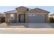Modern stucco home with a two-car garage and desert landscaping at 37405 W San Clemente St, Maricopa, AZ 85138