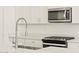 Stainless steel appliances and white shaker cabinets in kitchen at 37405 W San Clemente St, Maricopa, AZ 85138