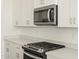 Modern gas cooktop and microwave in the kitchen at 37405 W San Clemente St, Maricopa, AZ 85138