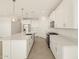 Open concept kitchen with white cabinets and island at 37405 W San Clemente St, Maricopa, AZ 85138