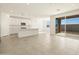 Open concept kitchen with island, stainless steel appliances, and patio access at 37405 W San Clemente St, Maricopa, AZ 85138