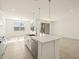 Open concept kitchen with island and view to backyard at 37405 W San Clemente St, Maricopa, AZ 85138