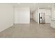 Open living room area with tile floors and access to hallway at 37405 W San Clemente St, Maricopa, AZ 85138