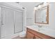 Bathroom featuring a glass-enclosed shower, vanity with cabinet storage, and updated fixtures at 10026 W Lancaster Dr, Sun City, AZ 85351