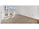 Bedroom featuring neutral carpet, white walls, and a set of modern windows at 10026 W Lancaster Dr, Sun City, AZ 85351