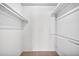 Walk-in closet with carpet flooring and built-in shelving for optimal storage at 10026 W Lancaster Dr, Sun City, AZ 85351