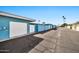 Neighborhood street featuring blue-colored townhomes with private garage entrances at 10026 W Lancaster Dr, Sun City, AZ 85351