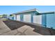 Light blue home featuring two garage doors, privacy walls and a paved driveway providing practical and secure parking at 10026 W Lancaster Dr, Sun City, AZ 85351