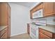 Efficient kitchen design featuring white appliances, microwave, and practical counter space at 10026 W Lancaster Dr, Sun City, AZ 85351