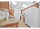 Functional kitchen with white refrigerator, ample cabinet space, and neutral countertops at 10026 W Lancaster Dr, Sun City, AZ 85351